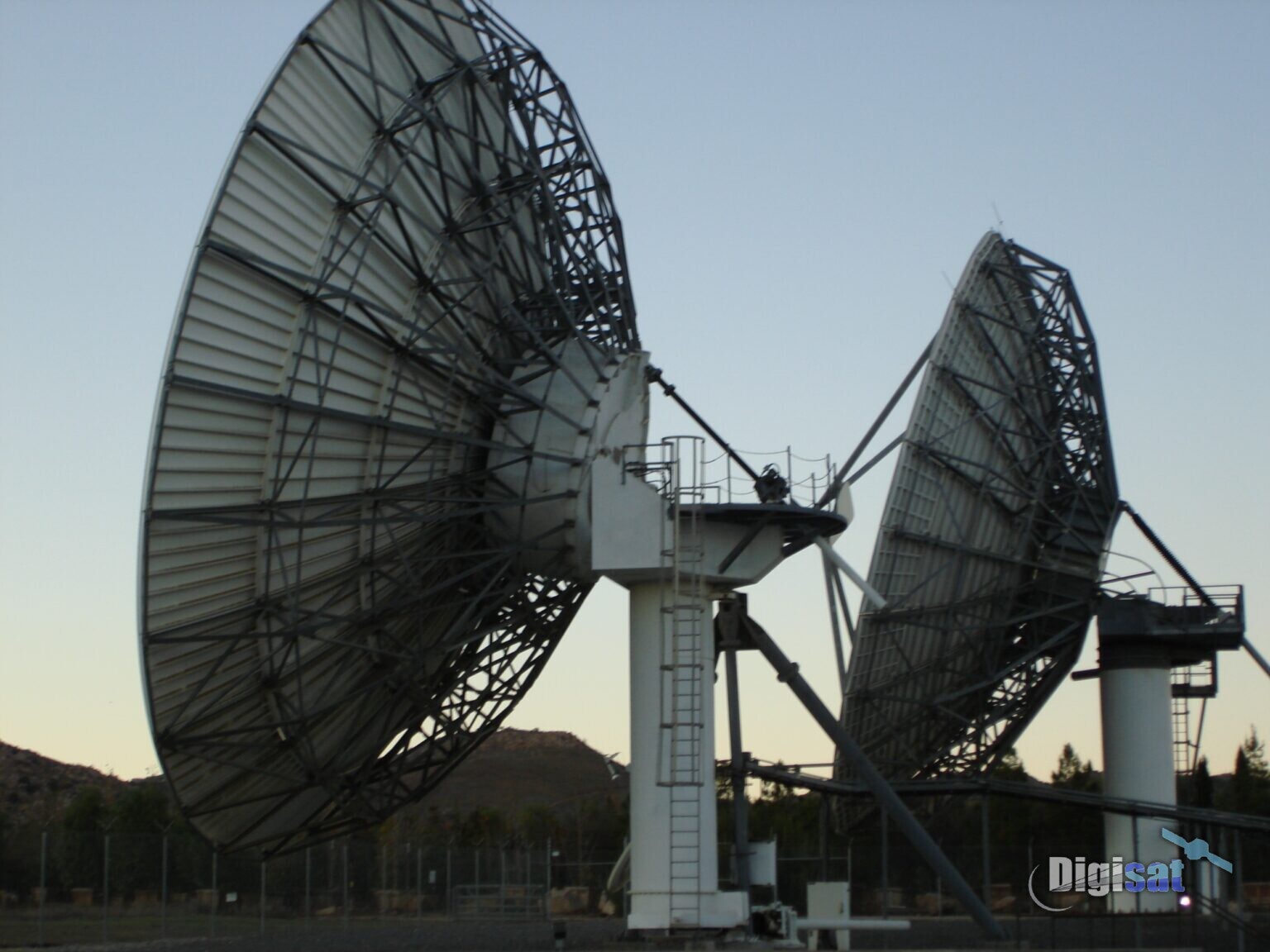 Two large earth station antennas at a ground station site
